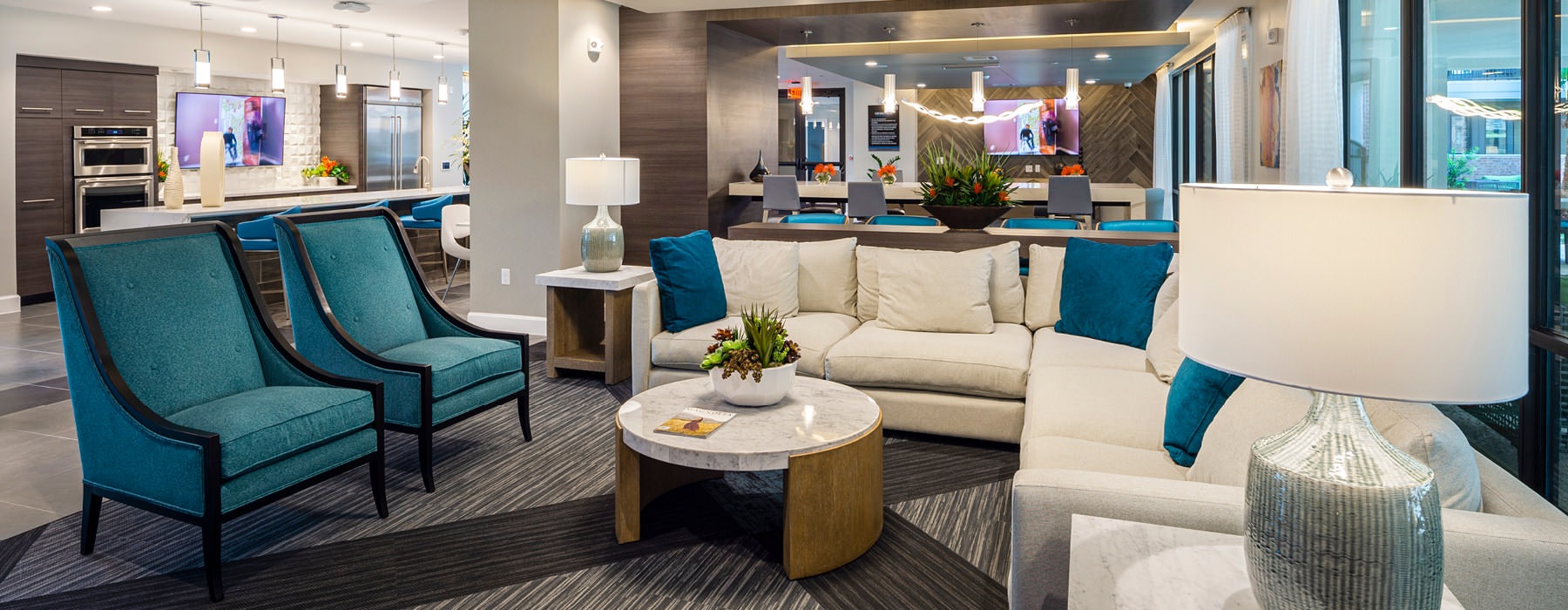 couches and plush chairs in amply lit clubhouse