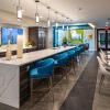 clubhouse kitchen with long island counter with pendant lighting